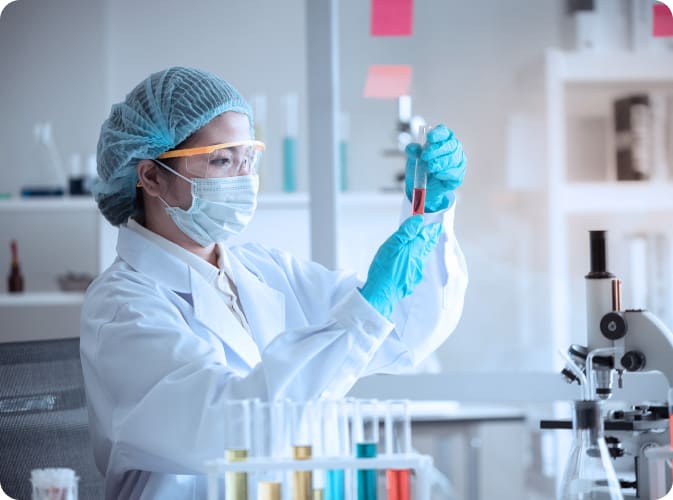 A medical technician is holding a sample from a BMAC procedure.